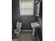 Bathroom featuring a toilet, pedestal sink, tiled floors, and a window for natural light at 2670 Foxlair Trl, South Fulton, GA 30349