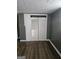 Bedroom featuring wood-look floors, neutral walls, and closet with bi-fold doors at 2670 Foxlair Trl, South Fulton, GA 30349