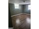 Bedroom with wood flooring, green walls, two windows with mini-blinds, and a ceiling light at 2670 Foxlair Trl, South Fulton, GA 30349