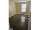 Bedroom with dark vinyl wood flooring, natural light streaming through the window, and a cozy atmosphere at 2670 Foxlair Trl, South Fulton, GA 30349