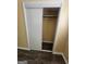 Bedroom closet with bi-pass doors revealing shelving and recently installed wood look vinyl flooring at 2670 Foxlair Trl, South Fulton, GA 30349