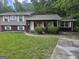 Charming split-level home with brick accents, arched porch, and well-maintained front lawn at 2670 Foxlair Trl, South Fulton, GA 30349