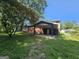 View of home's backyard featuring a covered carport and brick exterior at 2670 Foxlair Trl, South Fulton, GA 30349