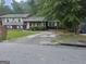 Charming split-level home with brick accents, arched porch, and well-maintained front lawn at 2670 Foxlair Trl, South Fulton, GA 30349
