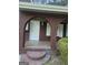 Covered front porch entrance with brick archways and a tile landing, offering a touch of architectural detail at 2670 Foxlair Trl, South Fulton, GA 30349