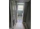 Hallway with a view of a bathroom featuring tile floors, toilet, and pedestal sink at 2670 Foxlair Trl, South Fulton, GA 30349