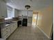 Kitchen with tiled flooring, white cabinets, black appliances, and double sink at 2670 Foxlair Trl, South Fulton, GA 30349