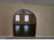 Arched doorway opens into a large living room with hardwood floors and natural light at 2670 Foxlair Trl, South Fulton, GA 30349