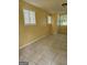 Spacious living room with tiled flooring and multiple windows for ample natural light at 2670 Foxlair Trl, South Fulton, GA 30349