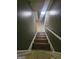 Staircase leading to a lower level with tiled landing and gray-painted walls at 2670 Foxlair Trl, South Fulton, GA 30349