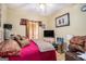 Cozy bedroom with ceiling fan, warm-toned walls, and a decorative painting hung over a chest of drawers at 2928 Mandy Ct, Jonesboro, GA 30236