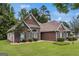 Angle shot showcasing the home's brick exterior and landscaped yard at 2928 Mandy Ct, Jonesboro, GA 30236