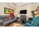 Comfortable living room featuring a large grey sofa, TV, storage, and a patterned rug creating a cozy gathering place at 2928 Mandy Ct, Jonesboro, GA 30236