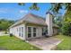 Exterior rear view featuring a neutral color, multiple windows, a chimney, and a small back patio at 2928 Mandy Ct, Jonesboro, GA 30236