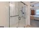 Modern bathroom showcasing a glass-door shower, marble-style walls, and neutral tones at 370 Grand Teton Cir, Fayetteville, GA 30215