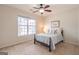 Cozy bedroom featuring a comfy bed, ceiling fan, and a bright window overlooking the outdoors at 370 Grand Teton Cir, Fayetteville, GA 30215