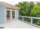 Outdoor deck with white railings, white lattice and French doors that lead to the inside living space at 370 Grand Teton Cir, Fayetteville, GA 30215