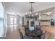 Open dining area with a decorative chandelier, hardwood floors, and views into other living spaces at 370 Grand Teton Cir, Fayetteville, GA 30215