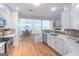 Modern kitchen with white cabinets, stainless steel appliances, and a view into the dining room at 370 Grand Teton Cir, Fayetteville, GA 30215