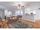 Open-concept living area with hardwood floors, a ceiling fan, and a view of the dining and kitchen areas at 370 Grand Teton Cir, Fayetteville, GA 30215