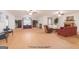 Spacious living room featuring hardwood floors, a fireplace, and multiple seating areas under modern ceiling fans at 370 Grand Teton Cir, Fayetteville, GA 30215
