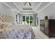 Bright bedroom features a king-sized bed, trey ceilings, and outdoor views at 55 Jolie Ln, Sharpsburg, GA 30277