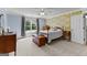 Bright bedroom with floral wallpaper, a ceiling fan, and a sun-drenched window overlooking the lush backyard at 55 Jolie Ln, Sharpsburg, GA 30277