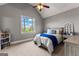 Bedroom with pitched ceiling, ceiling fan, and large window with views of the outside at 55 Jolie Ln, Sharpsburg, GA 30277