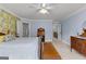 Spacious bedroom featuring blue walls, floral accents, and multiple doorways to bathroom and living areas at 55 Jolie Ln, Sharpsburg, GA 30277