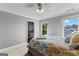 Well-lit bedroom with large windows providing scenic views and an adjacent bathroom for added convenience at 55 Jolie Ln, Sharpsburg, GA 30277