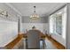 Elegant dining room with wainscoting, hardwood floors, and a chandelier at 55 Jolie Ln, Sharpsburg, GA 30277