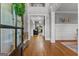 Inviting foyer with gleaming hardwood floors, wainscoting, neutral paint, and view into formal living spaces at 55 Jolie Ln, Sharpsburg, GA 30277