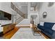 Spacious living room with hardwood floors, staircase, and view of the entryway at 55 Jolie Ln, Sharpsburg, GA 30277
