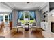 Cozy living room featuring hardwood floors, a fireplace, and large windows with backyard views at 55 Jolie Ln, Sharpsburg, GA 30277