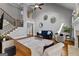 Open-concept living room features hardwood floors, staircase, and a comfortable seating area at 55 Jolie Ln, Sharpsburg, GA 30277