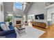 Open-concept living room with fireplace, high ceilings and hardwood floors at 55 Jolie Ln, Sharpsburg, GA 30277