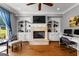 Comfortable living room with hardwood floors, built-in shelving, fireplace and large window at 55 Jolie Ln, Sharpsburg, GA 30277