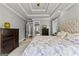 Elegant main bedroom suite with trey ceilings, patterned bedding, and adjoining bathroom and closet at 55 Jolie Ln, Sharpsburg, GA 30277