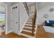 Staircase with wood treads, iron spindles and wooden handrail, with entry and living room views at 55 Jolie Ln, Sharpsburg, GA 30277