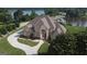 Beautiful aerial view of a stately brick home nestled near a tranquil lake at 413 Canterbury Way, Jonesboro, GA 30236