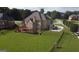 Aerial view of an estate home, showing the spacious backyard, brick exterior, and surrounding landscaping at 413 Canterbury Way, Jonesboro, GA 30236