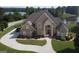 Stunning aerial view of a brick home with circular driveway near a lake at 413 Canterbury Way, Jonesboro, GA 30236