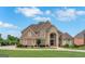 Stunning brick home with manicured lawn and circular driveway, exuding curb appeal and charm at 413 Canterbury Way, Jonesboro, GA 30236