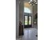 Grand foyer with a glass door, chandelier, and marble floors, creating a striking entrance at 413 Canterbury Way, Jonesboro, GA 30236