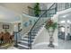 Elegant foyer with a curved staircase, wrought iron railings, and marble flooring with decor at 413 Canterbury Way, Jonesboro, GA 30236