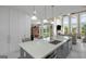 Open concept kitchen features an island with breakfast bar and overlooks the living room at 413 Canterbury Way, Jonesboro, GA 30236