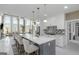 Open-concept kitchen with an oversized island, pendant lighting, and modern appliances at 413 Canterbury Way, Jonesboro, GA 30236