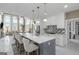 Open concept kitchen features an island with breakfast bar, stainless steel appliances, and modern backsplash at 413 Canterbury Way, Jonesboro, GA 30236
