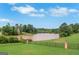 Scenic lake view from the backyard with a wrought iron fence at 413 Canterbury Way, Jonesboro, GA 30236