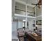 Living room features a second story with decorative railing overlooking the entrance and front of the house at 413 Canterbury Way, Jonesboro, GA 30236